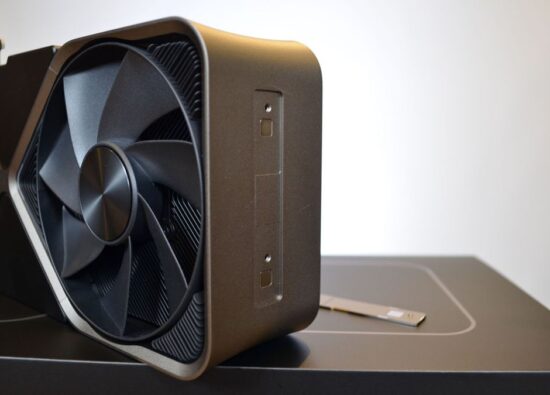 An Nvidia GeForce RTX 4080 on a wooden desk in front of a white panel